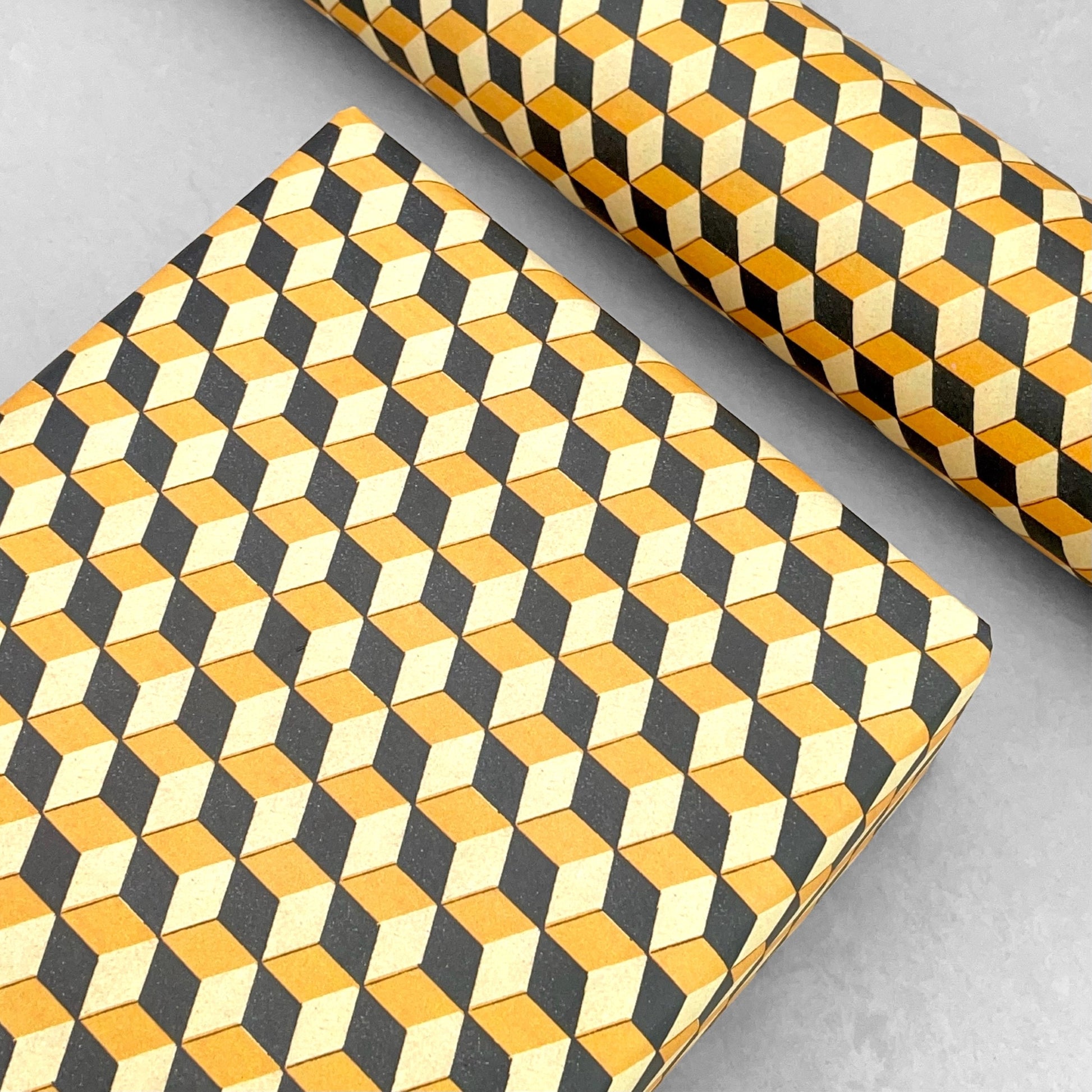 Italian patterned wrapping paper "Carta Varese" by Grafiche Tassotti. A pattern of yellow, black and lemon geometric cubes with a 3D effect