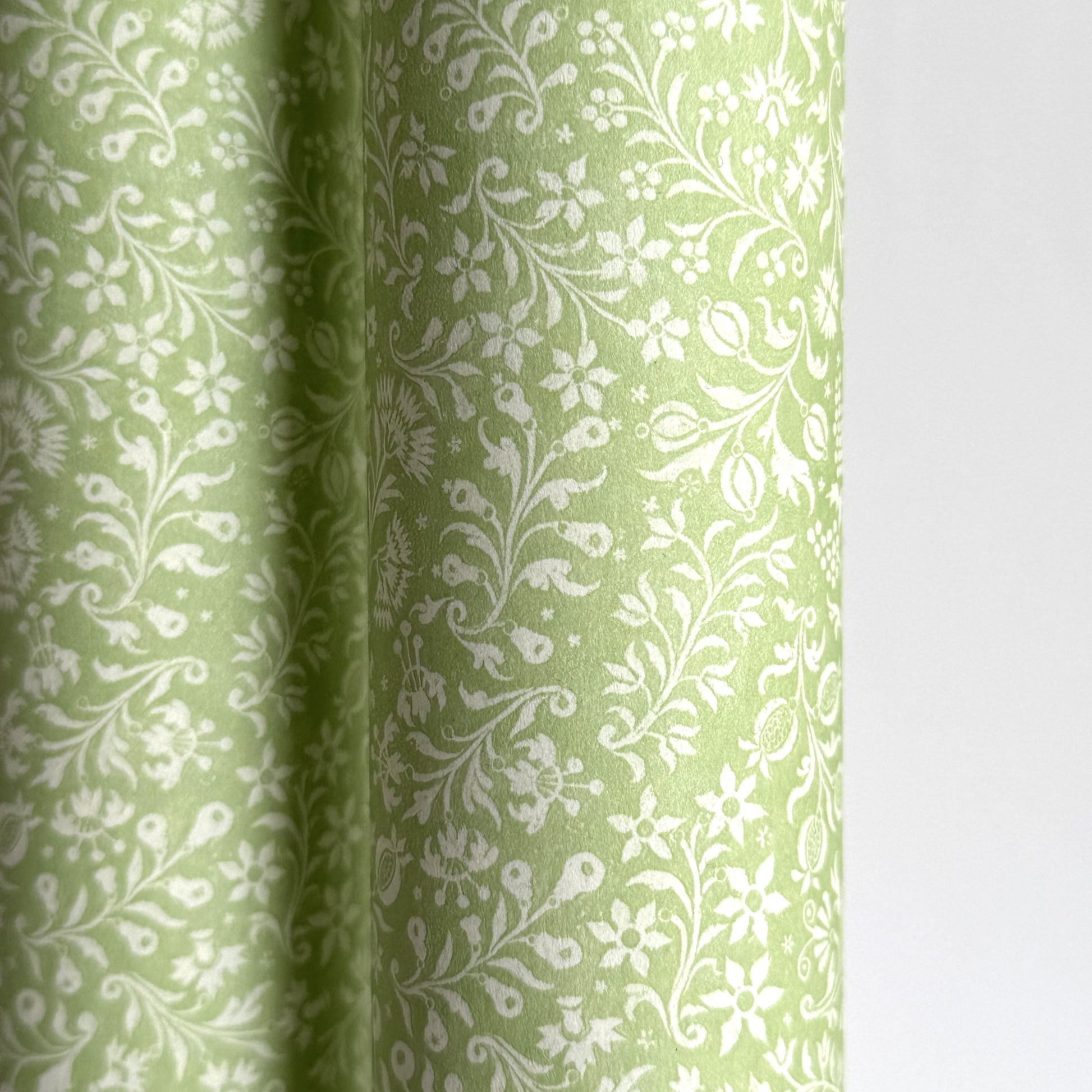 a sheet of italian wrapping paper with a delicate small floral design in light green and white