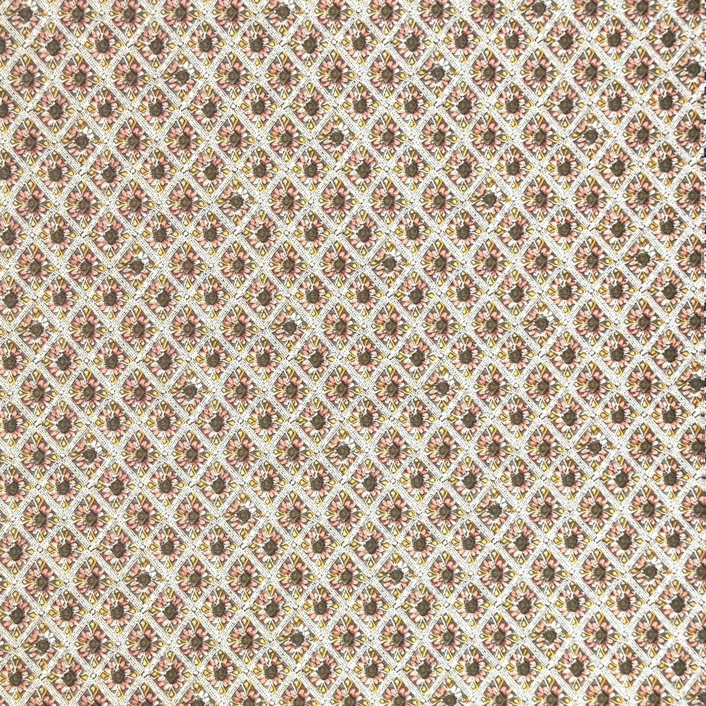 a sheet of italian wrapping paper with little flowers in a diamond grid in soft olive, pink and yellow