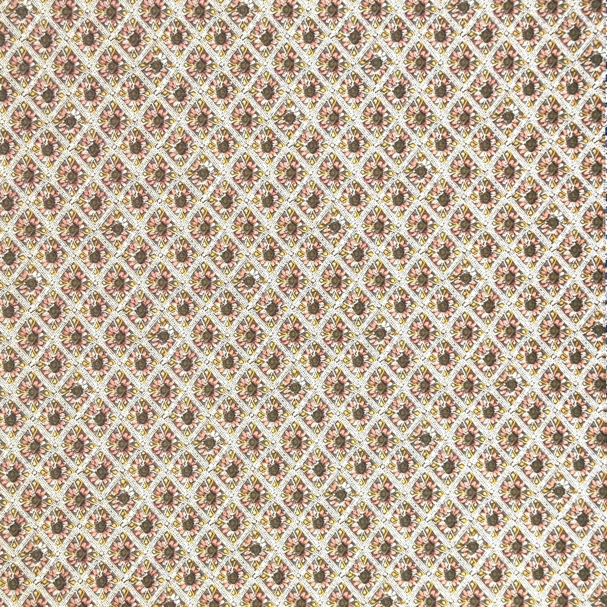 a sheet of italian wrapping paper with little flowers in a diamond grid in soft olive, pink and yellow