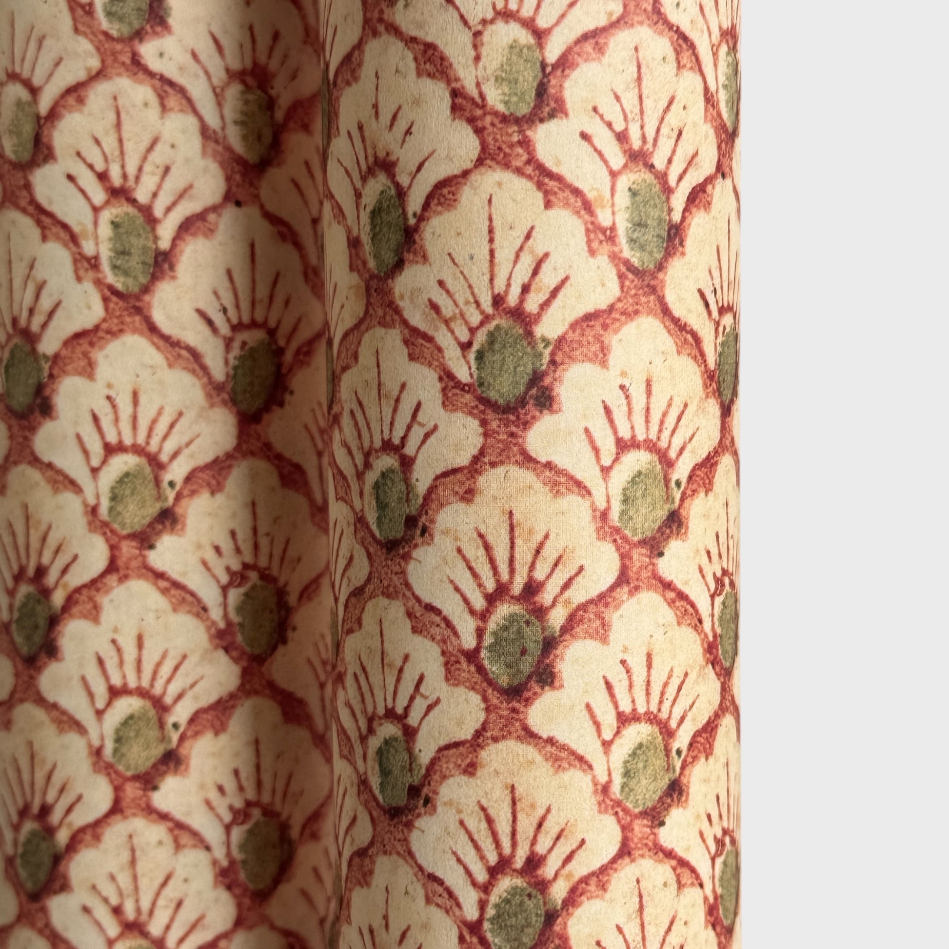 a sheet of italian wrapping paper with a shell repeat pattern in soft coral, cream and olive green