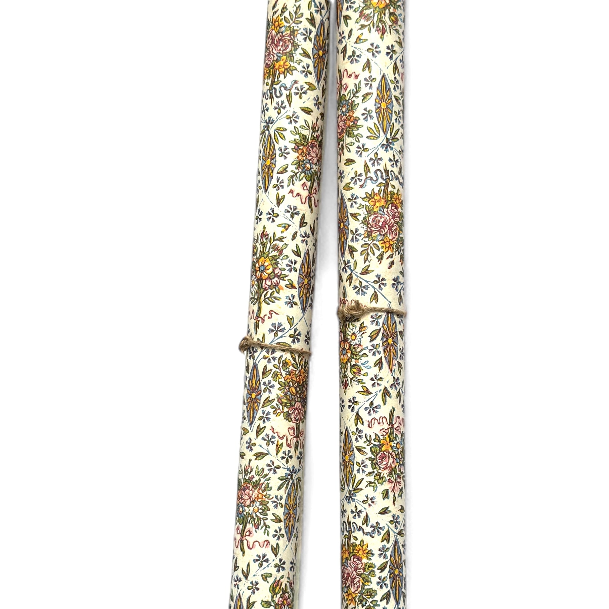 a sheet of italian wrapping paper with a mutlicoloured floral pattern on white. Pictured rolled