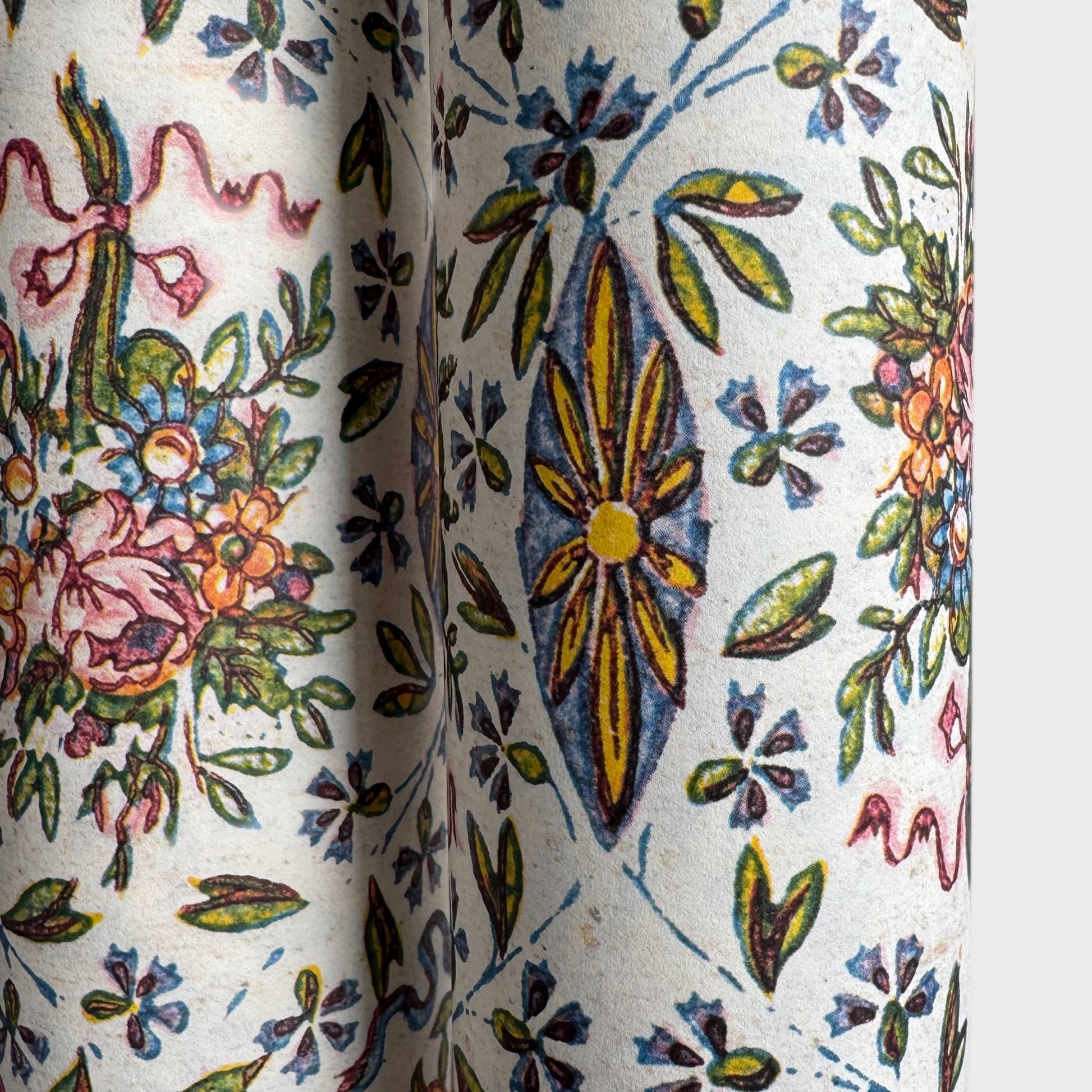 a sheet of italian wrapping paper with a mutlicoloured floral pattern on white