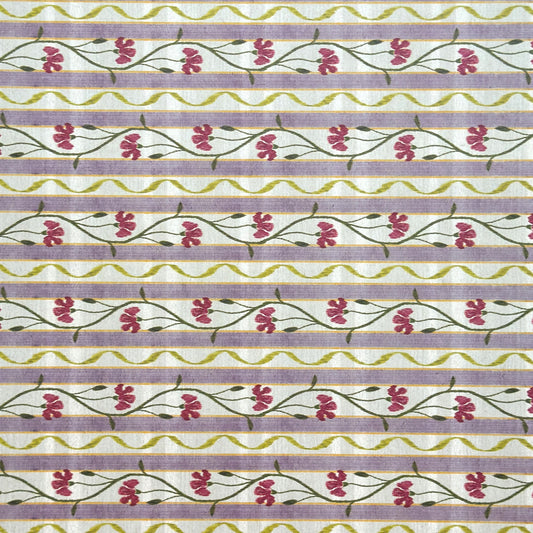 A close-up of a patterned wrapping paper featuring horizontal lavender and cream stripes with pink flowers, green stems, and olive-green wavy lines.