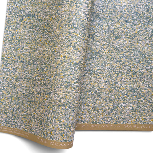 a sheet of printed marbled paper with a marble pattern in sage green, butter yellow, soft grey and white.