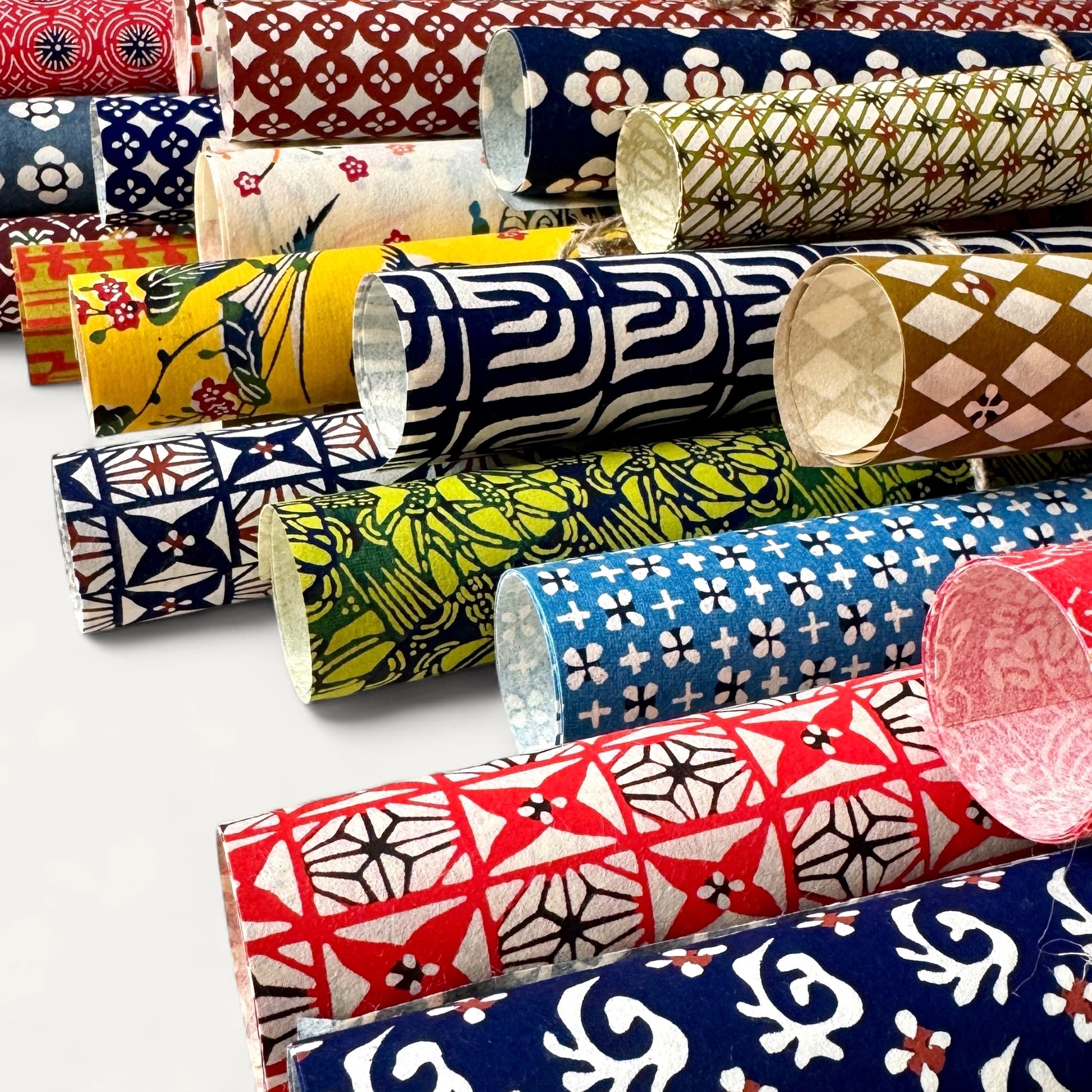 vintage katazome stencil dyed papers.  Lots of different colourful designs pictured rolled