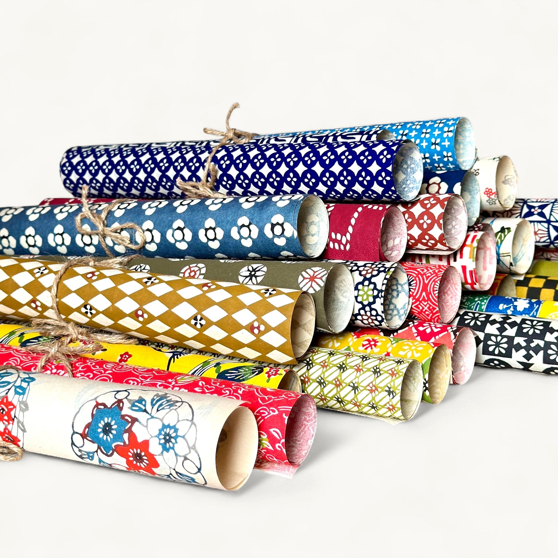 vintage katazome stencil dyed papers.  Lots of different colourful designs pictured rolled and stacked