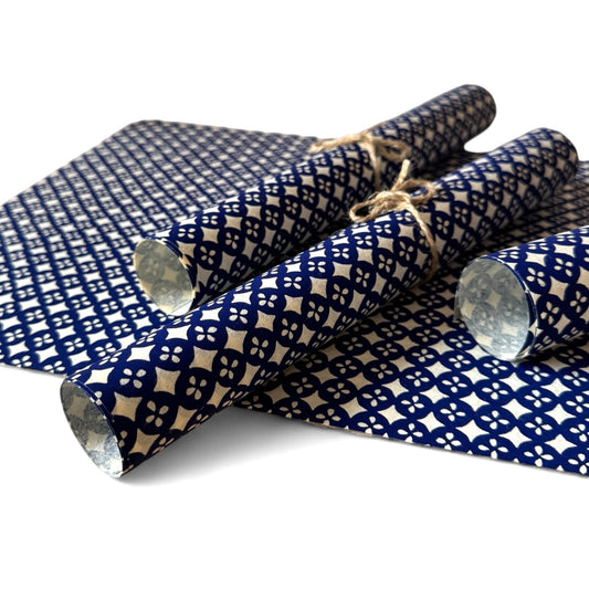 vintage katazome-shi stencil-dyed small papers from Japan.  blue circle pattern on white background. Pictured rolled.