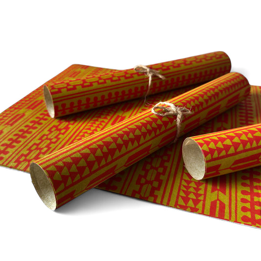 vintage katazome-shi stencil-dyed small papers from Japan. Aztek style pattern in gold and red. Pictured rolled.