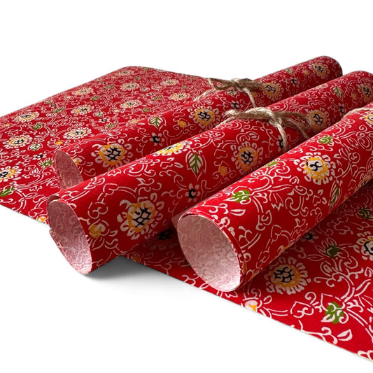 vintage katazome-shi stencil-dyed small papers from Japan. Japanese floral pattern in red, white, yellow and green. Pictured rolled.