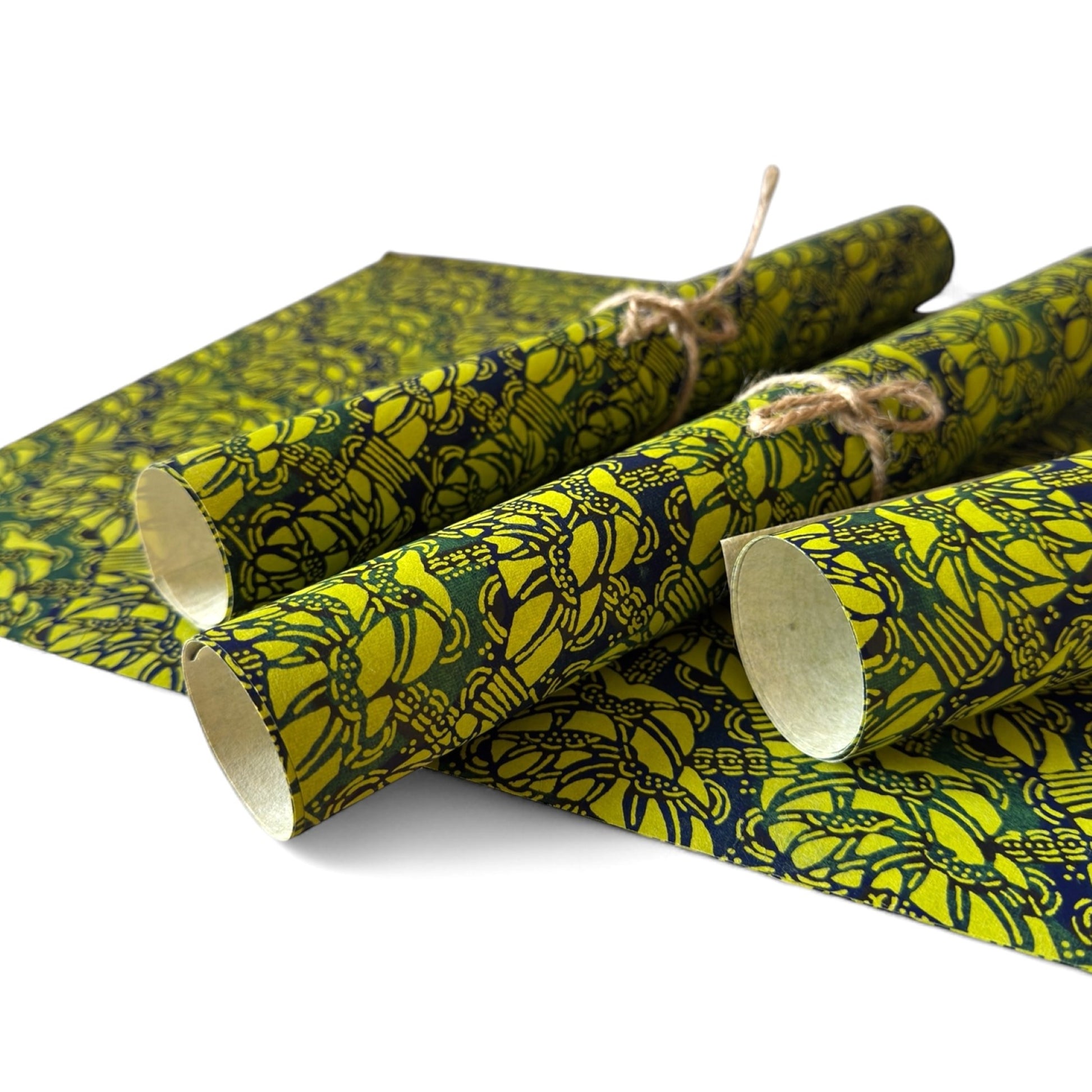 vintage katazome-shi stencil-dyed small papers from Japan. Lime green paper with dark green and blue Japanese botanical pattern. Pictured rolled.