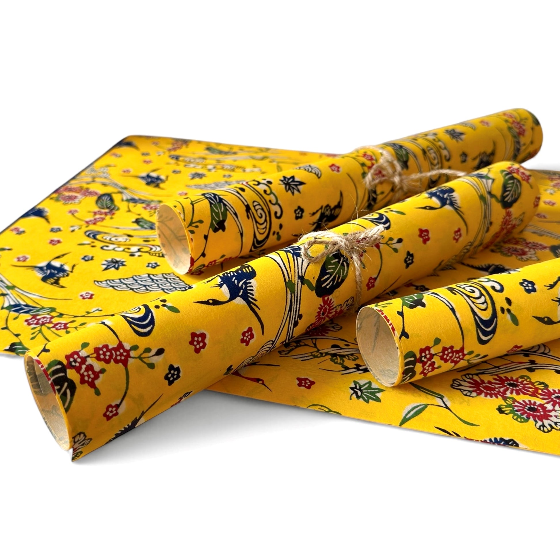 vintage katazome-shi stencil-dyed small papers from Japan. Yellow paper with Japanese cranes in red, blue and green. Pictured rolled.