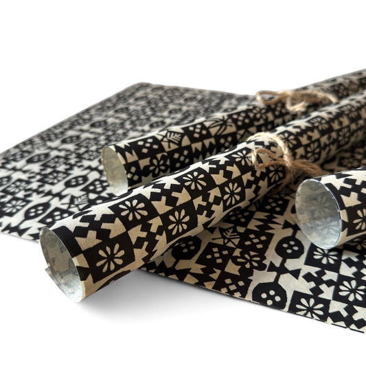 vintage katazome-shi stencil-dyed small papers from Japan. Cream paper with black geometric design. Pictured rolled.