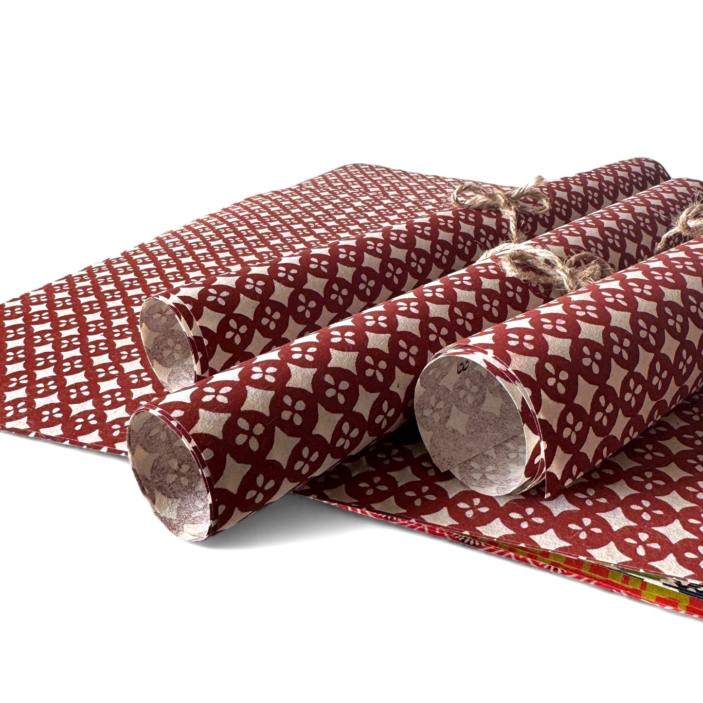 vintage katazome-shi stencil-dyed small papers from Japan. Cream paper with terracotta circles pattern. Pictured rolled.