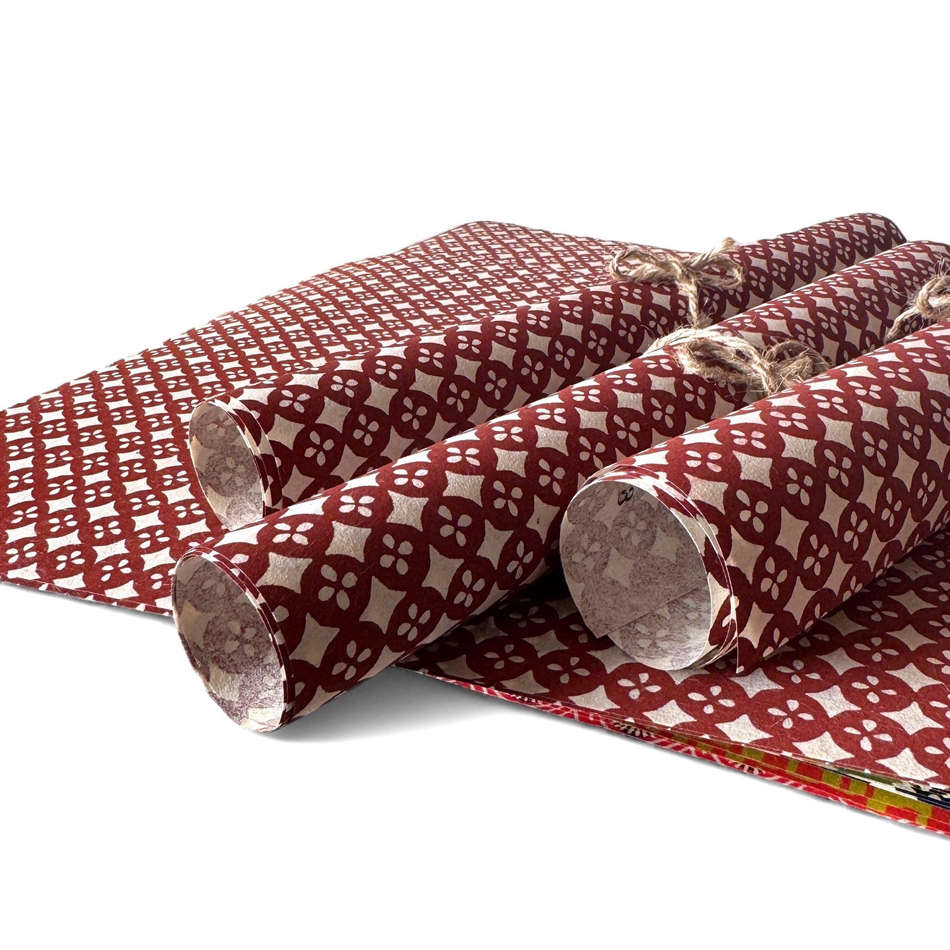 vintage katazome-shi stencil-dyed small papers from Japan. Cream paper with terracotta circles pattern. Pictured rolled.