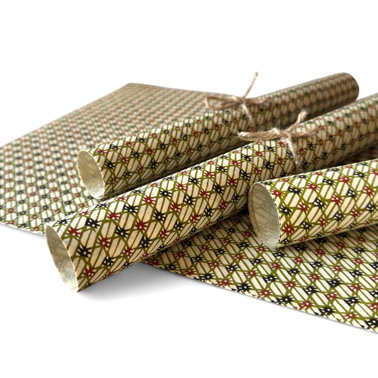 vintage katazome-shi stencil-dyed small papers from Japan. Cream paper with olive and red lattice pattern. Pictured rolled.