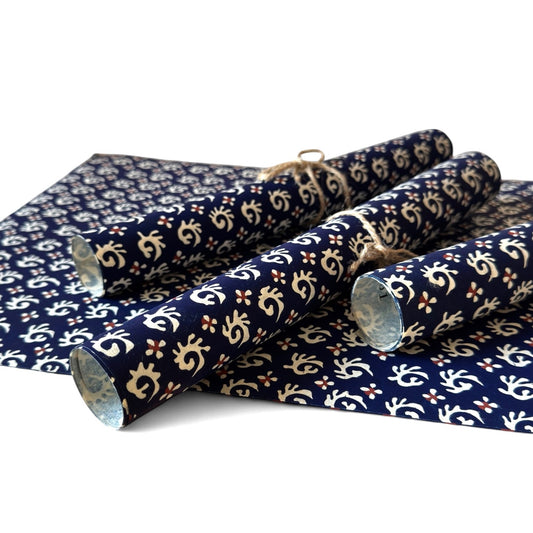 vintage katazome-shi stencil-dyed small papers from Japan. Navy paper with cream swirls. Pictured rolled.