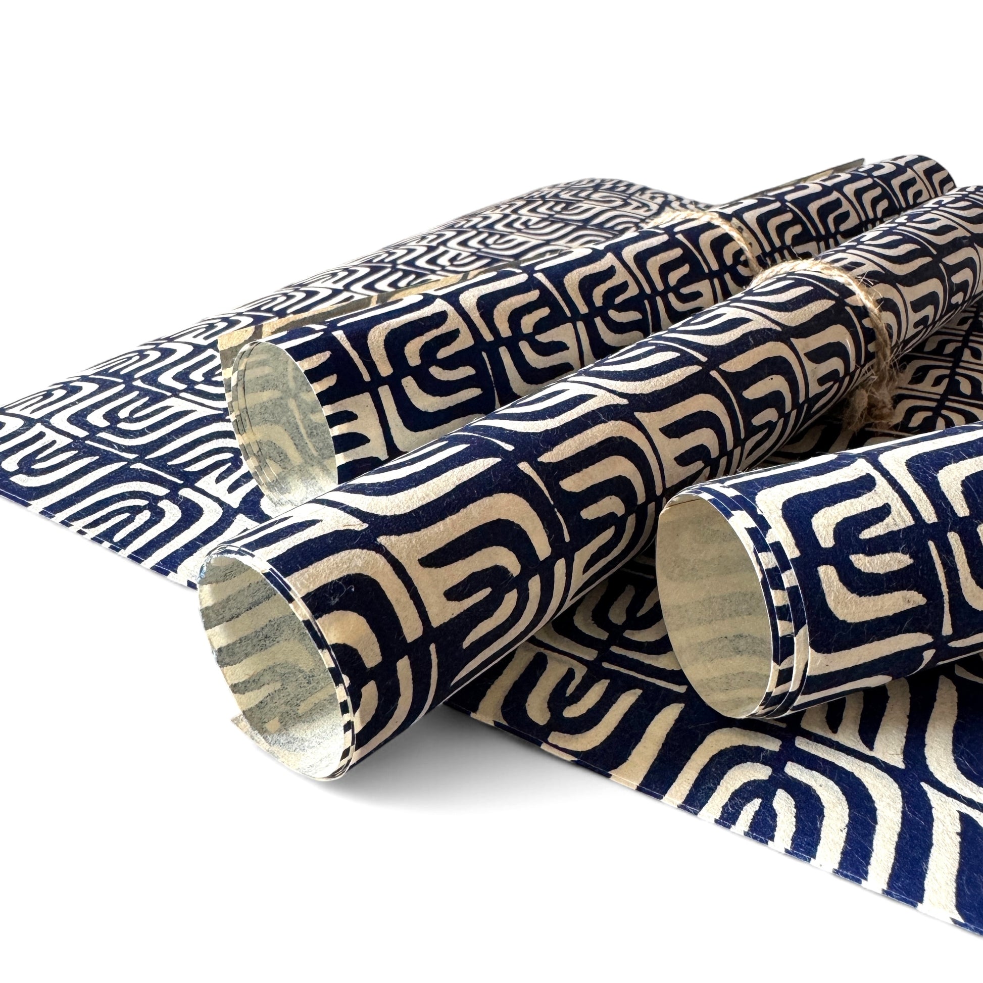vintage katazome stencil dyed paper. cream paper with a navy wave pattern. Pictured rolled