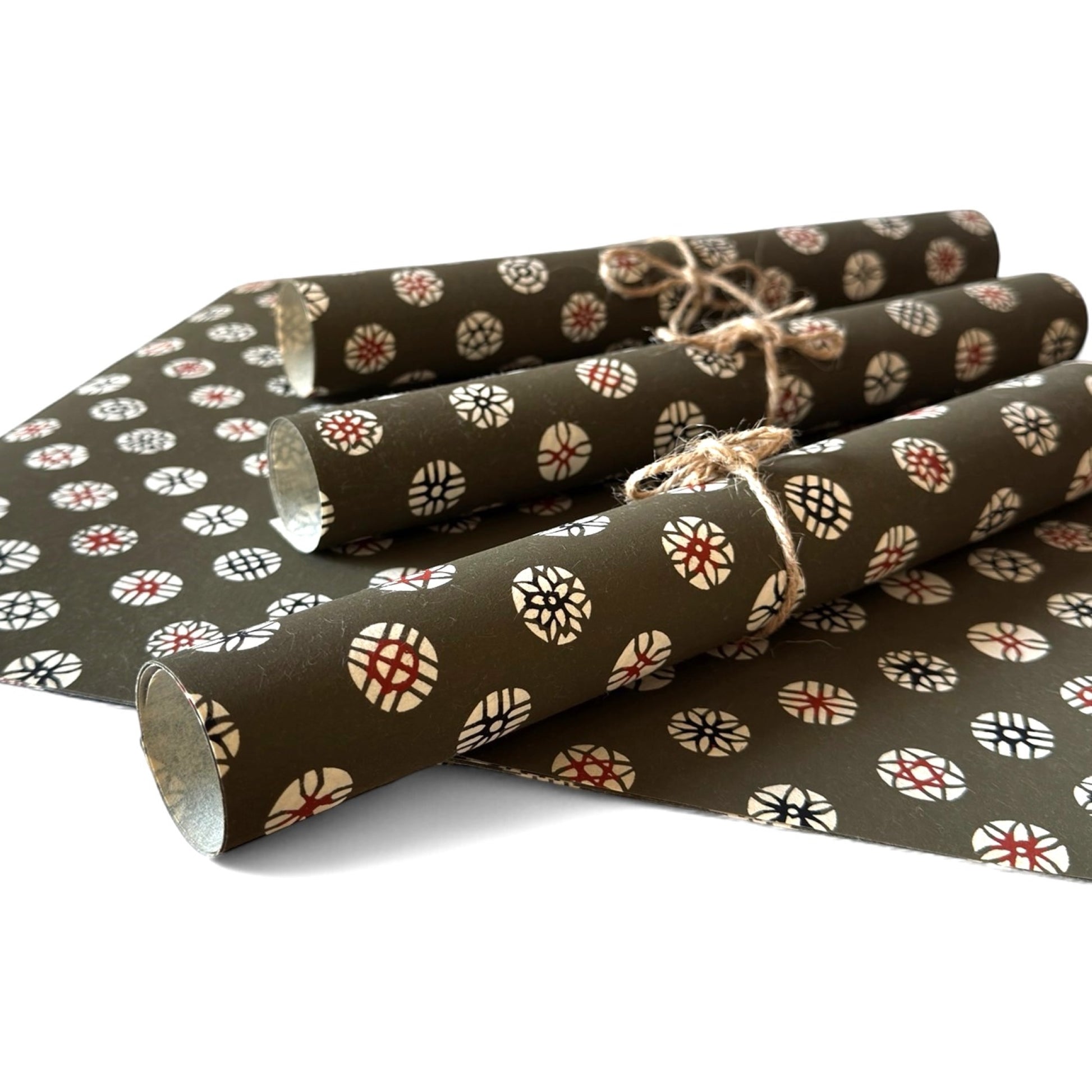 vintage katazome stencil dyed paper. Taupe paper with cream and red japanese circle motifs. Pictured rolled