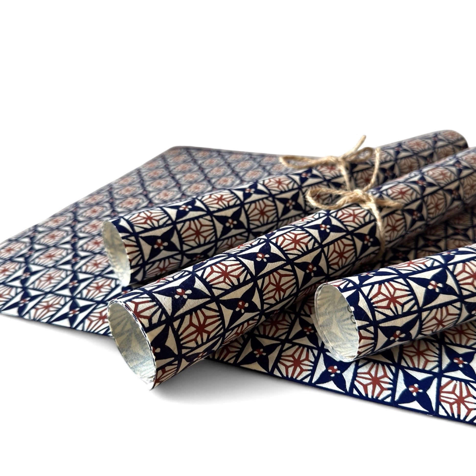 vintage katazome stencil dyed paper. Navy and red star pattern on cream paper. Pictured rolled