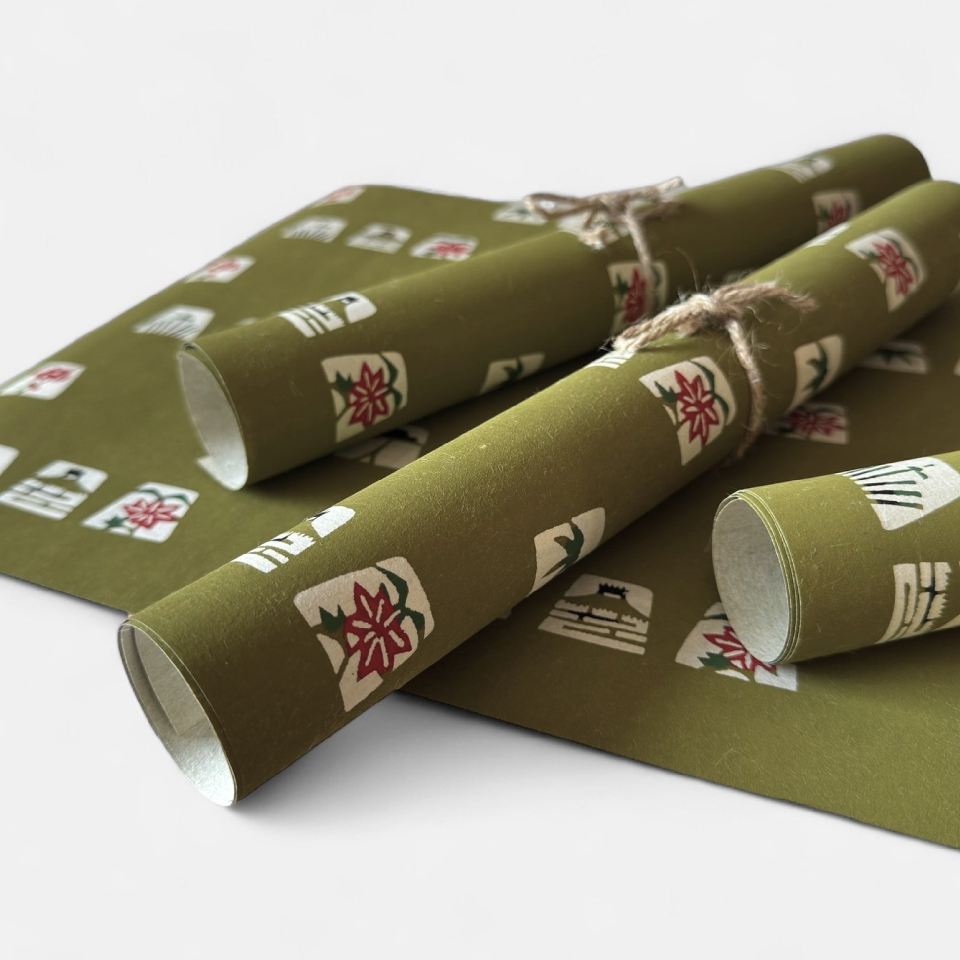 vintage katazome stencil dyed paper. Olive green paper with cream japanese motifs. Pictured rolled