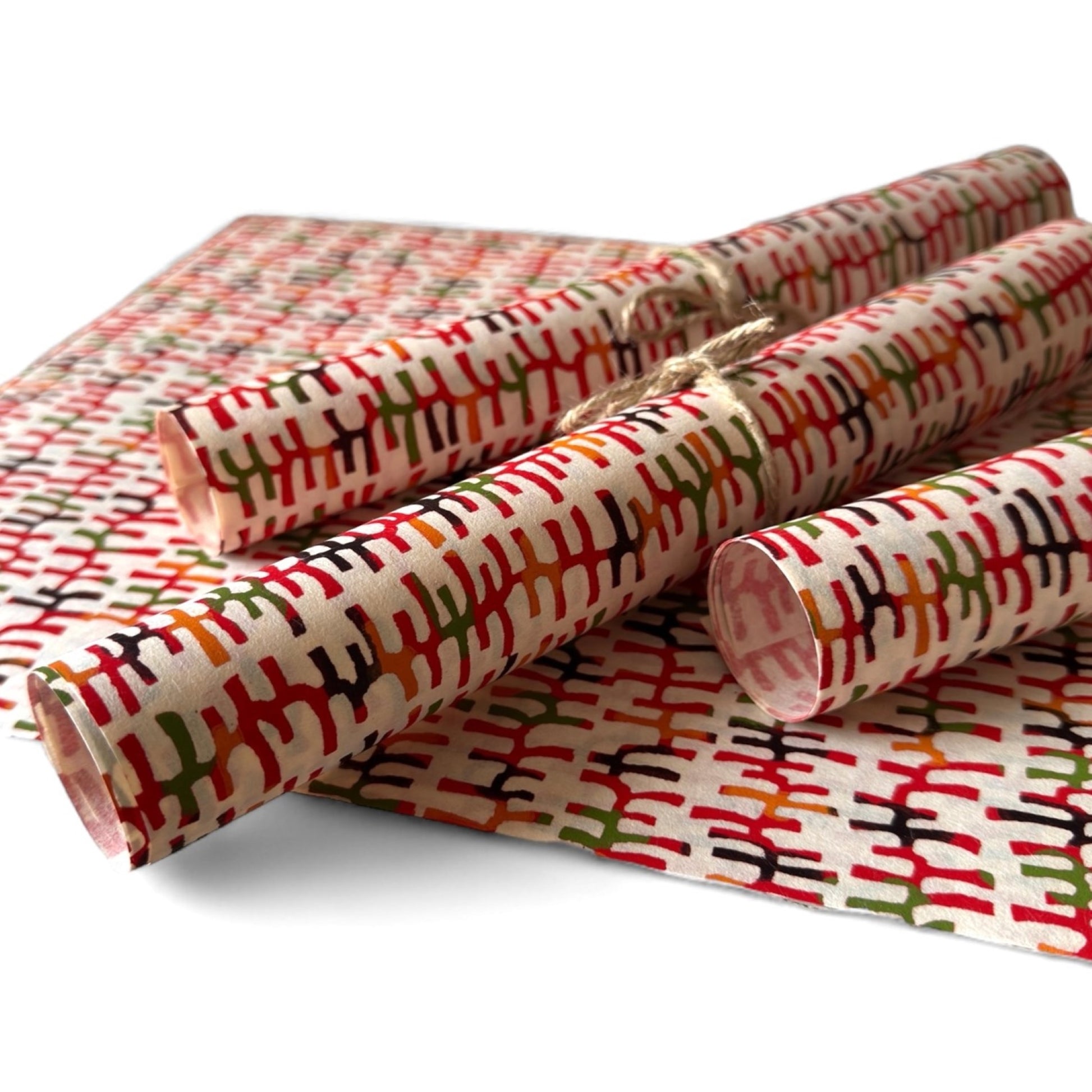 vintage katazome stencil dyed paper. Ivory background with multicoloured lines. Pictured rolled