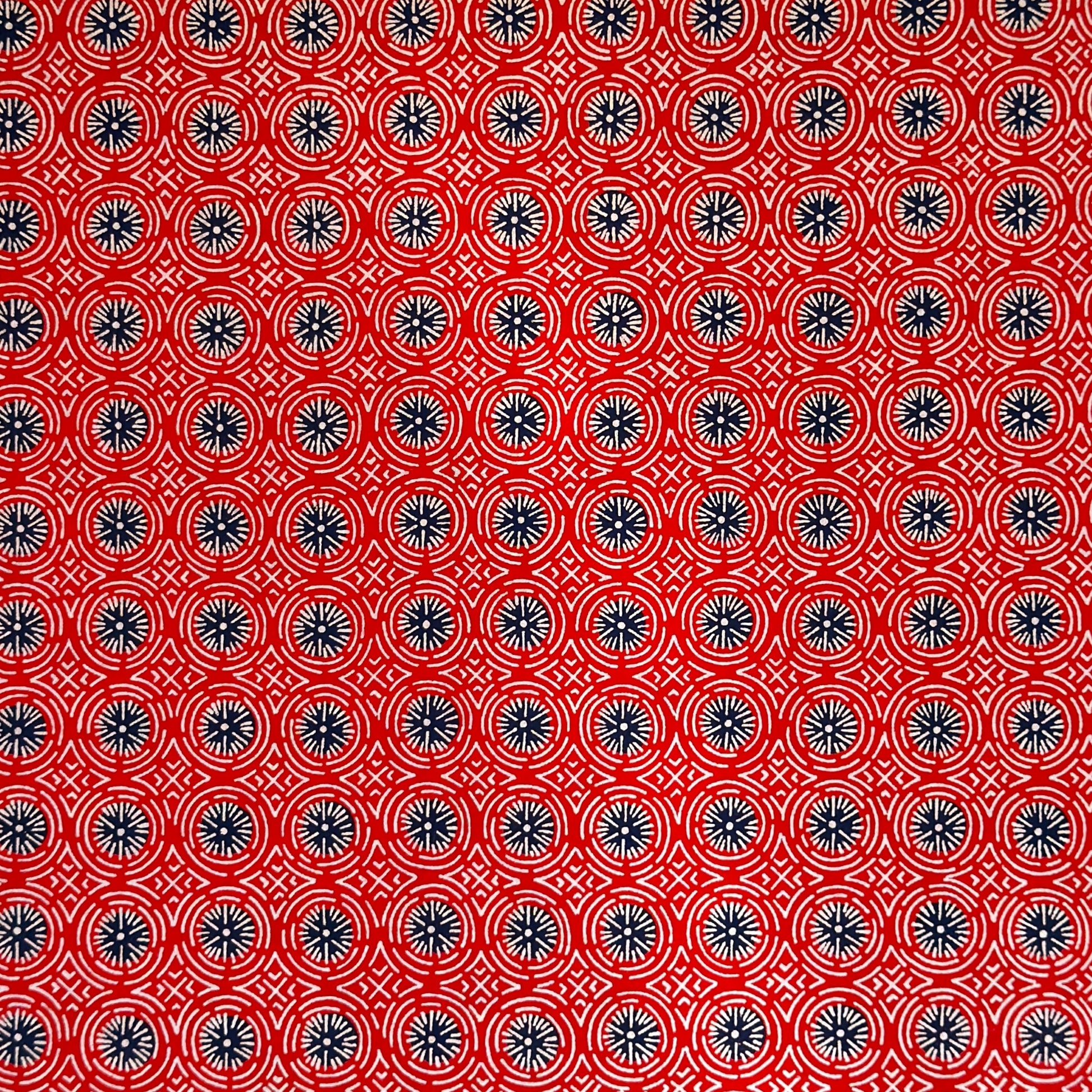 vintage katazome stencil dyed paper. red geometric design with dark blue circles and white lines.