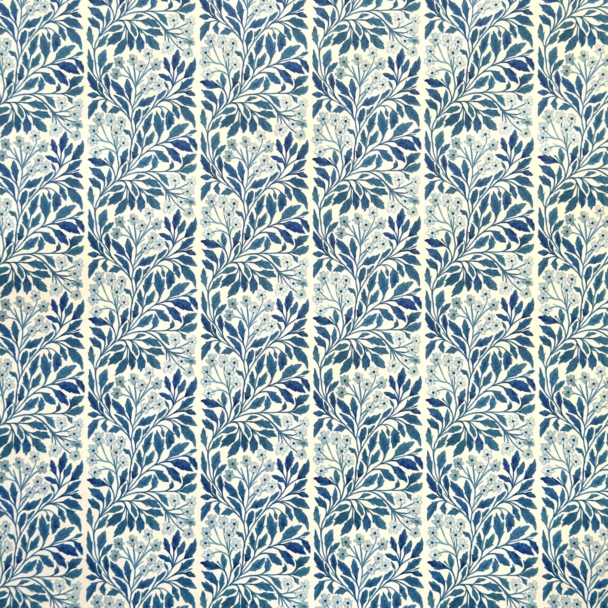 patterned paper / gift wrap with a delicate floral repeat pattern in blue on a ivory background.  By Wanderlust