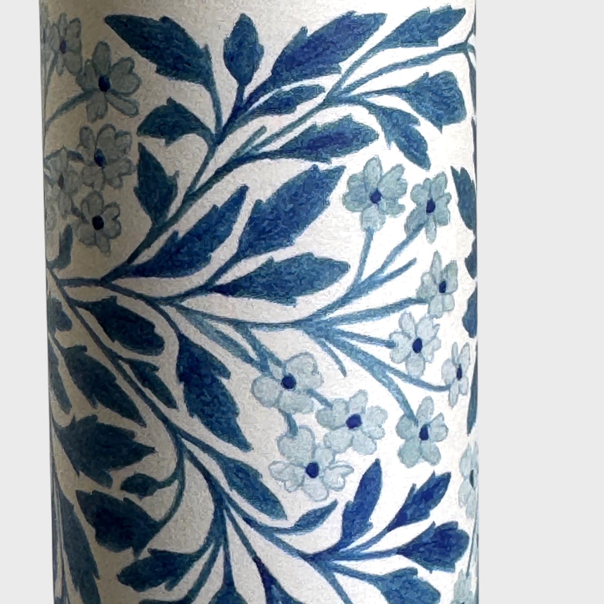 patterned paper / gift wrap with a delicate floral repeat pattern in blue on a ivory background.  By Wanderlust. Close up