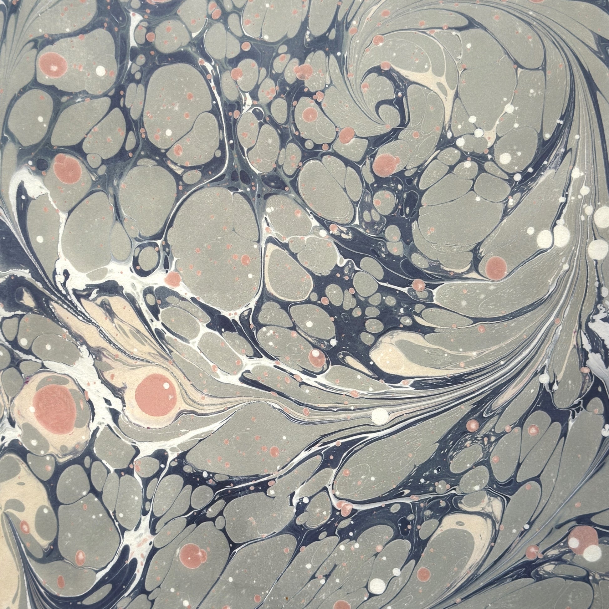 Printed marbled wrapping paper in dusty blue, grey and pink.