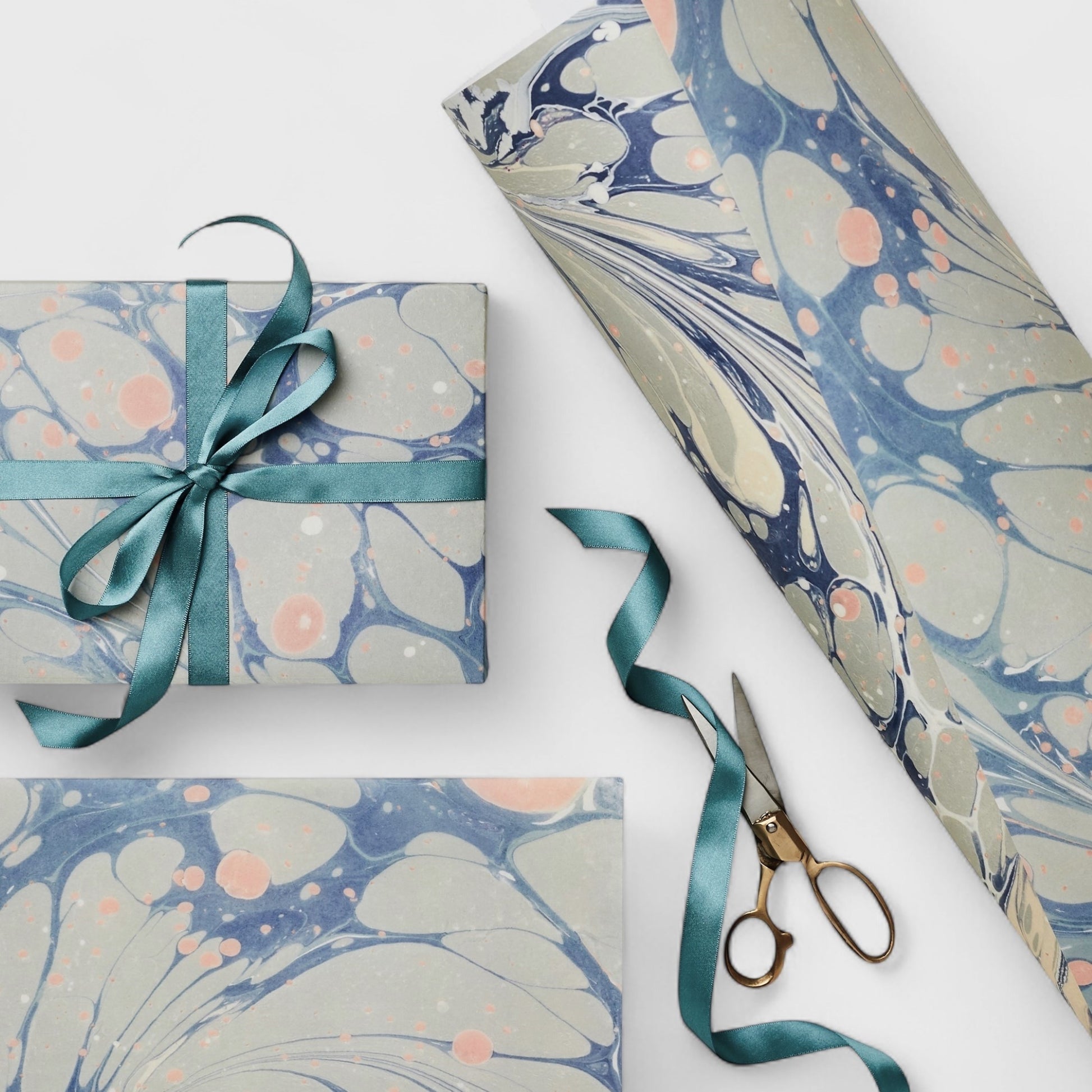 Printed marbled wrapping paper in dusty blue, grey and pink. Pictured wrapped
