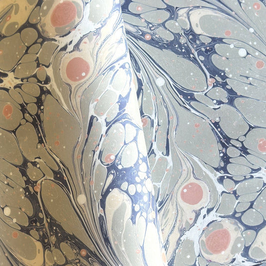 Printed marbled wrapping paper in dusty blue, grey and pink.