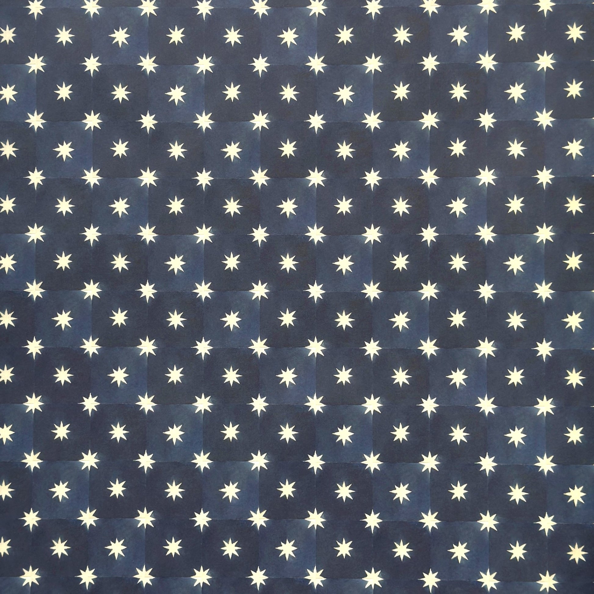 chequered navy blue with cream stars patterned wrapping paper