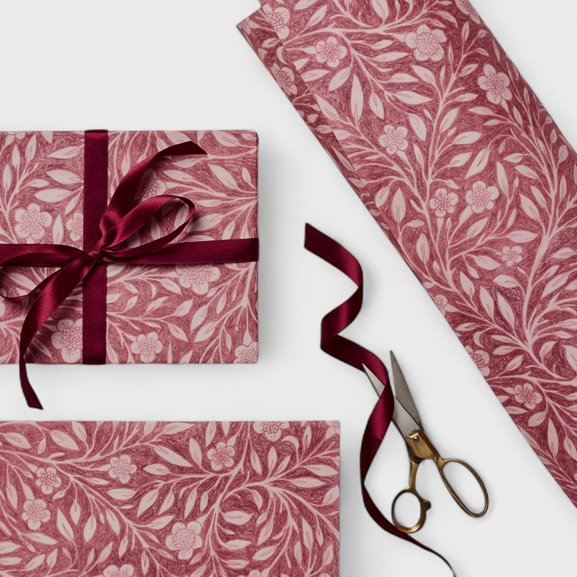 patterned paper / gift wrap with a delicate floral pattern in deep pink and white by Wanderlust. Pictured wrapped