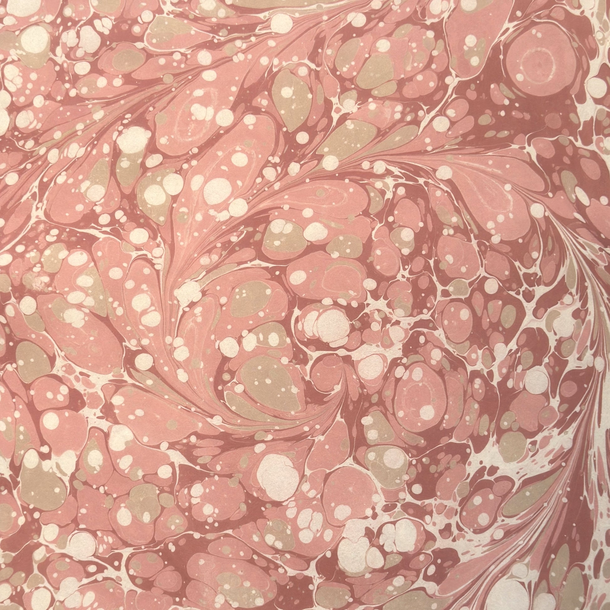Printed marbled wrapping paper in dusty pink, taupe and white.