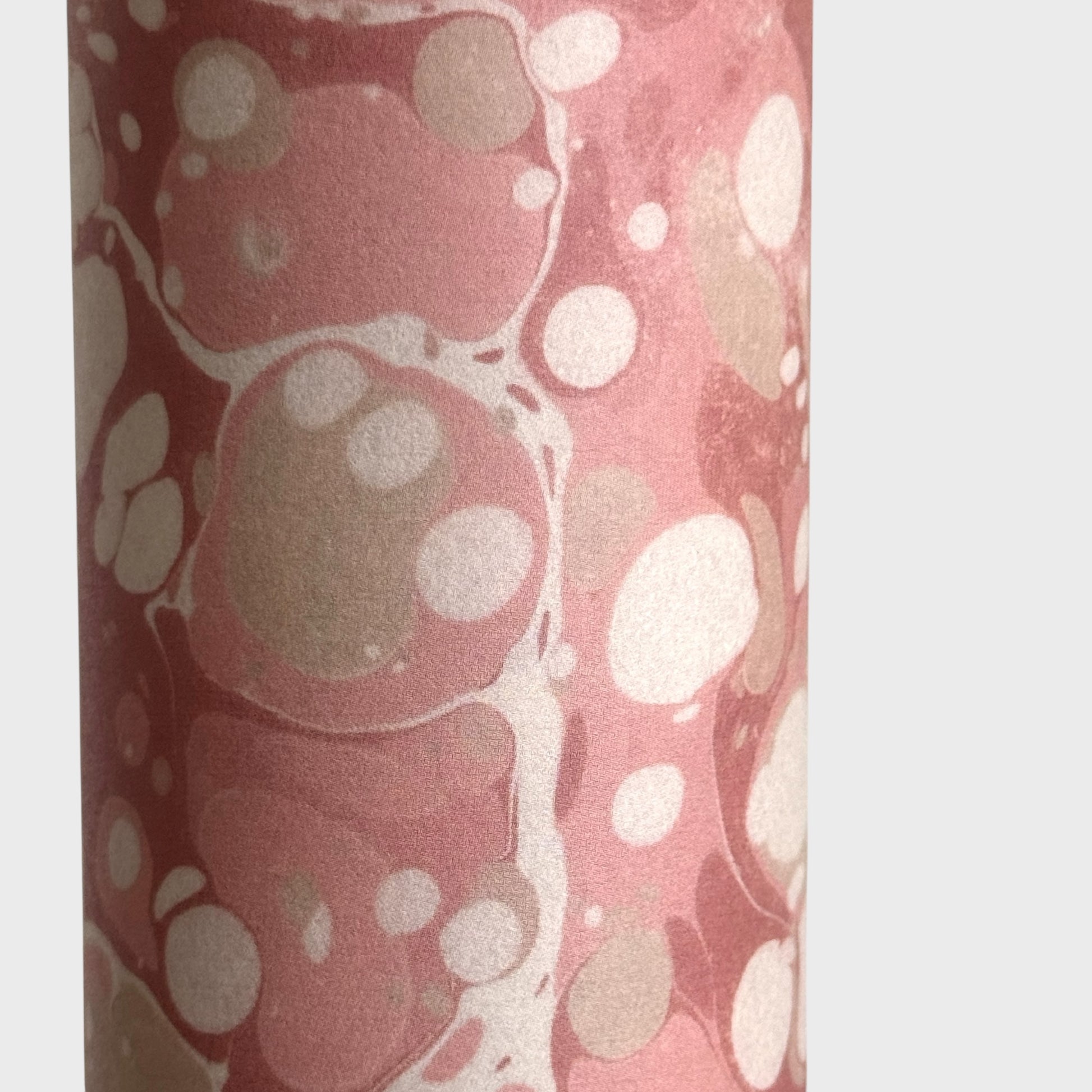 Printed marbled wrapping paper in dusty pink, taupe and white. Close up