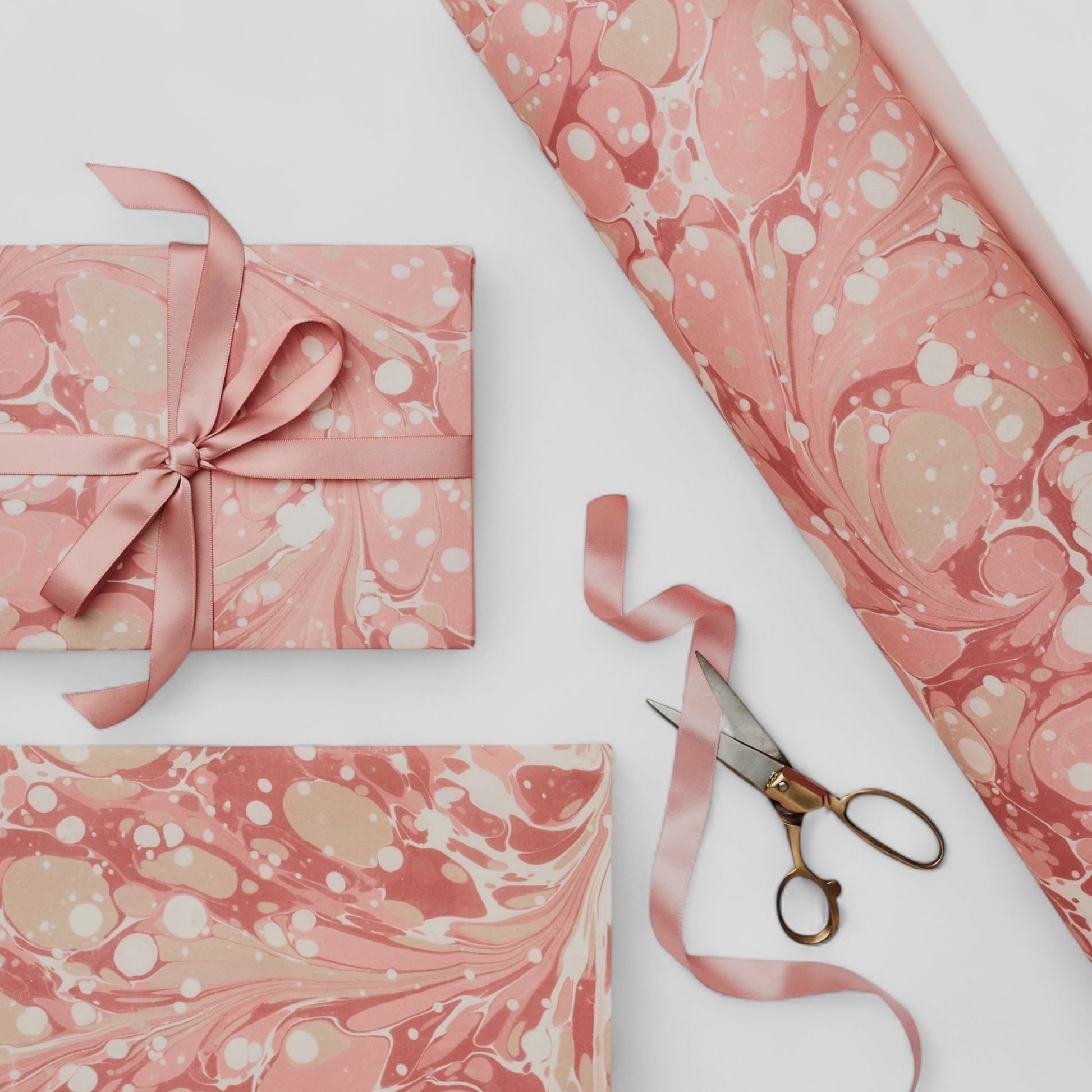 Printed marbled wrapping paper in dusty pink, taupe and white. Pictured wrapped