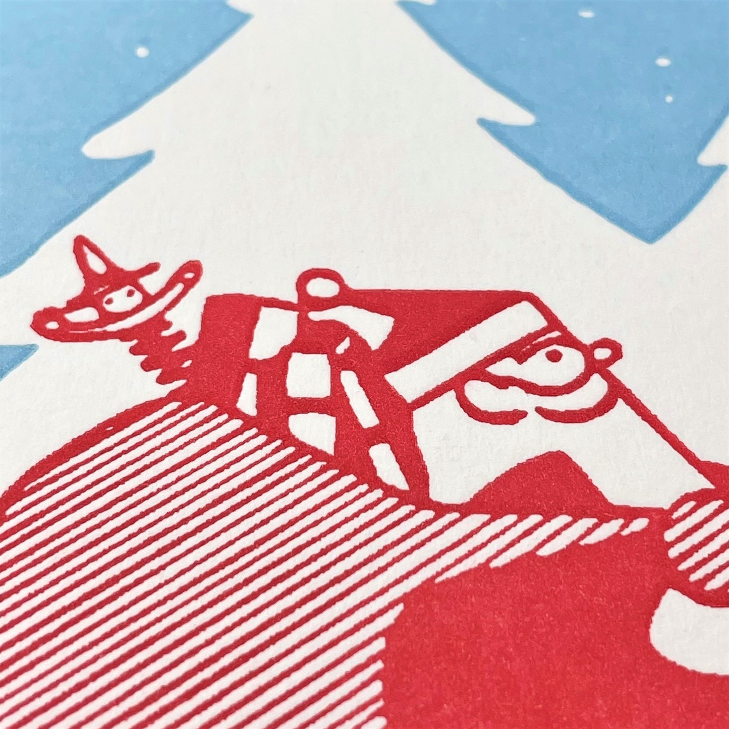 small greetings card with father christmas carrying a bag of presents close up of the card