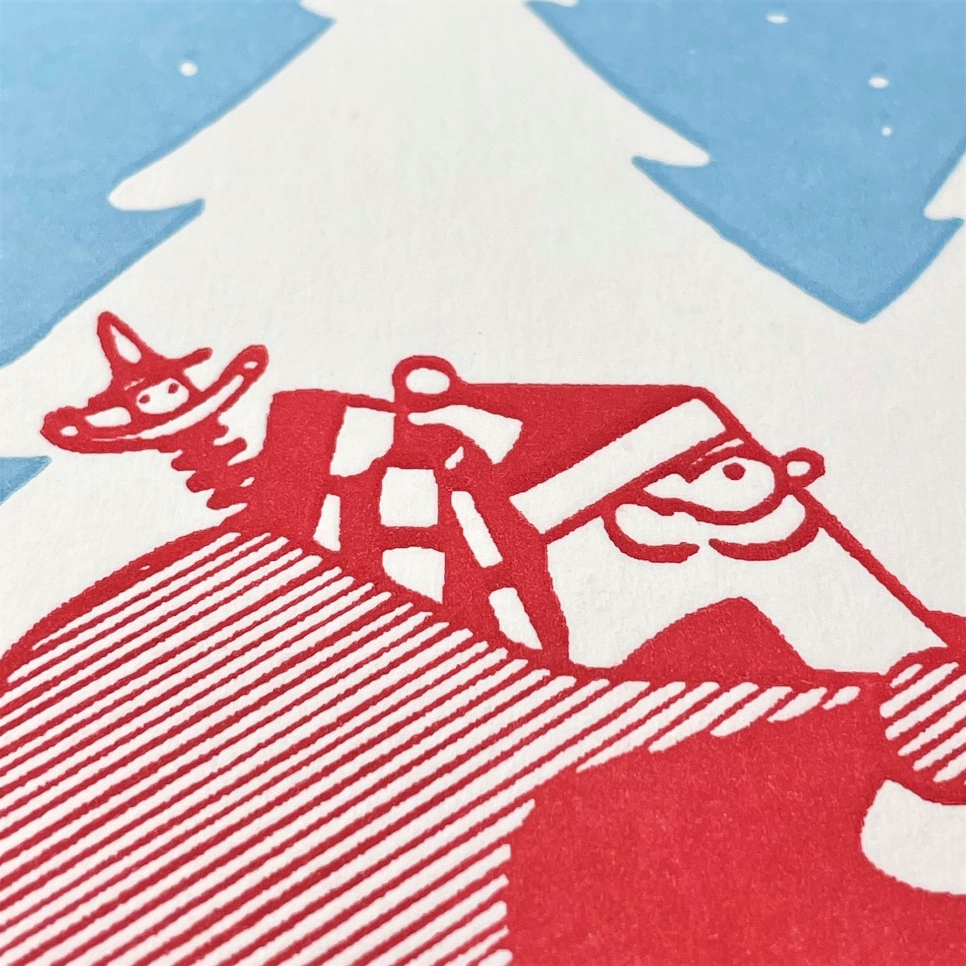 small greetings card with father christmas carrying a bag of presents close up of the card