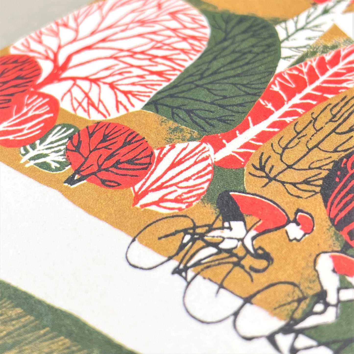 greetings card showing cyclists on a winding hilly road, close up of the card