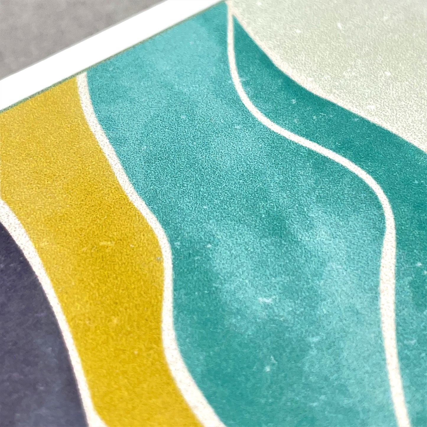 greetings card of a sun in the sky over a desert, close up of the card