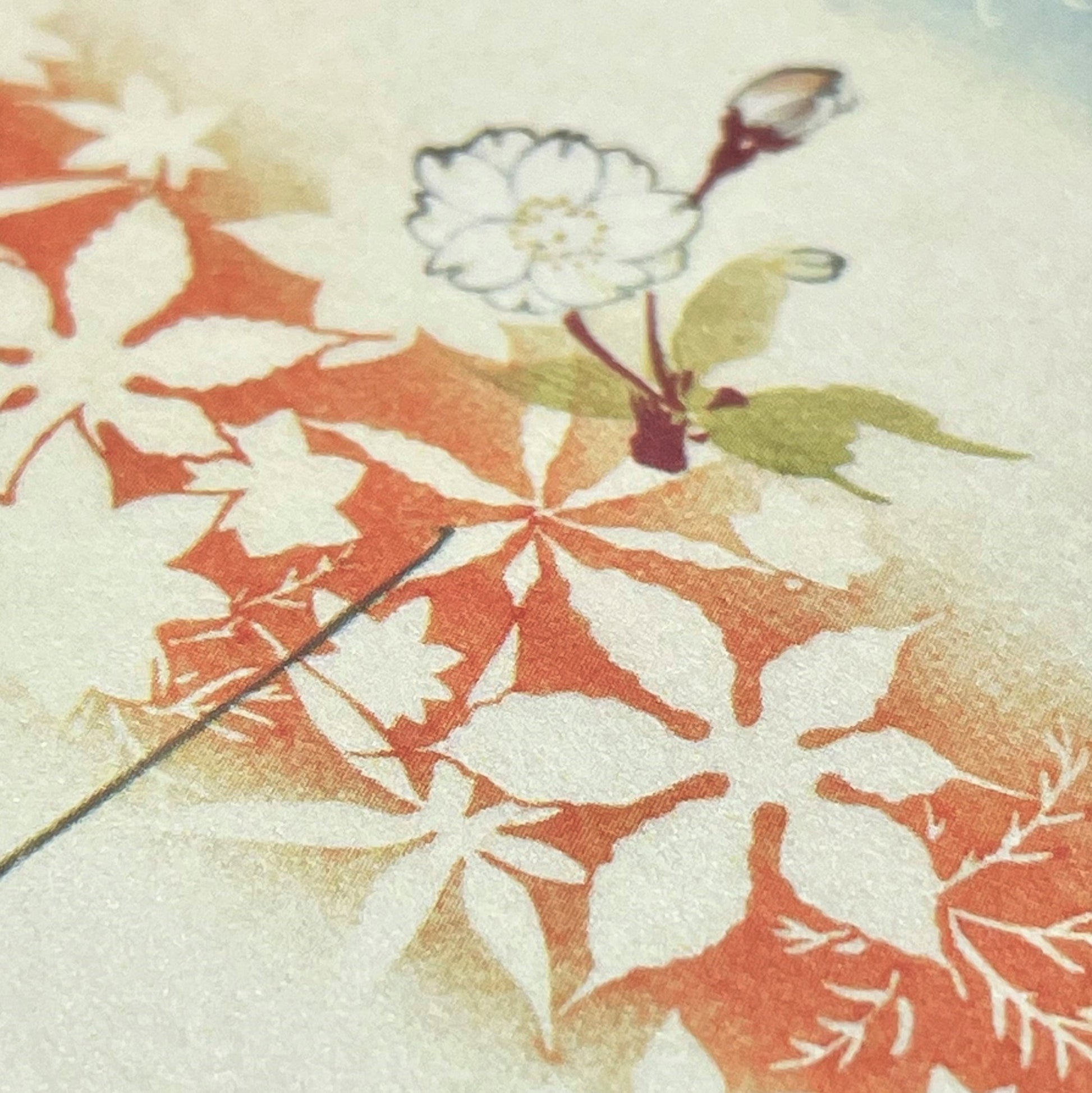 greetings card of a drawing of a floral folded kimono in red, yellow. blue and pink, close up of the pattern
