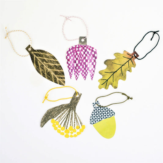A set of five different plant shaped gift tags in colours of green, yellow and purple, with colourful string by Hadley Paper Goods