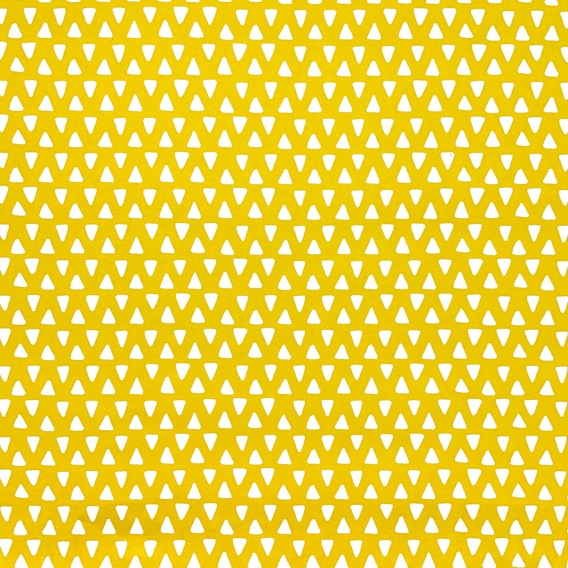 wrapping paper with yellow background and repeat pattern of little white triangles by Heather Evelyn