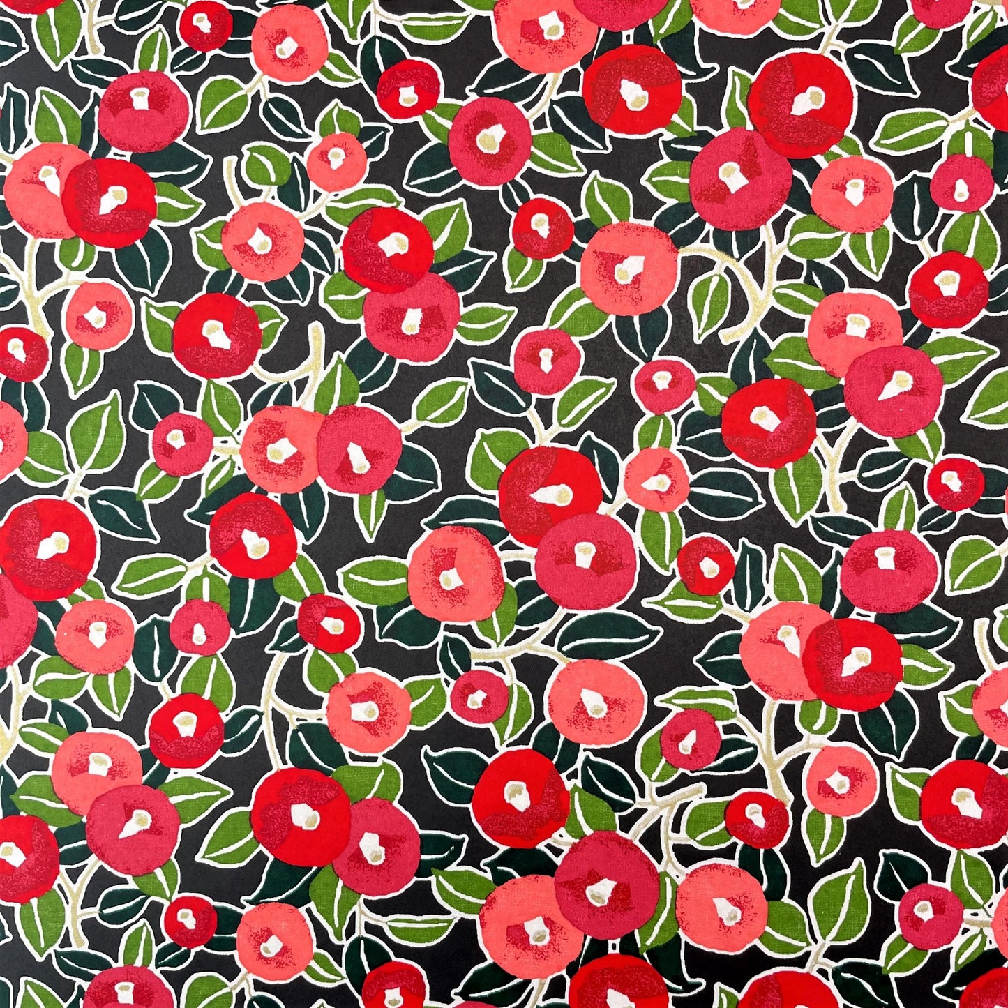 japanese silk-screen handmade paper, chiyogami, with a design showing red and pink morning glory flowers and green leaves on black background