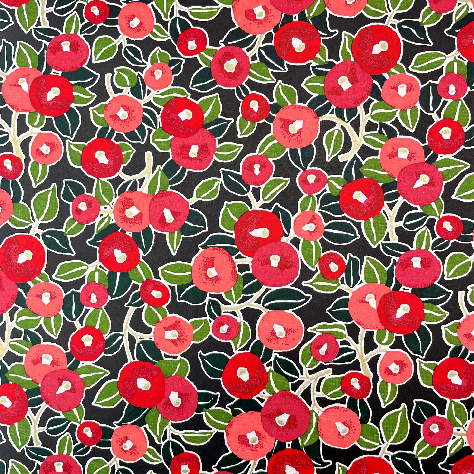 japanese silk-screen handmade paper, chiyogami, with a design showing red and pink morning glory flowers and green leaves on black background