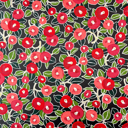 japanese silk-screen handmade paper, chiyogami, with a design showing red and pink morning glory flowers and green leaves on black background