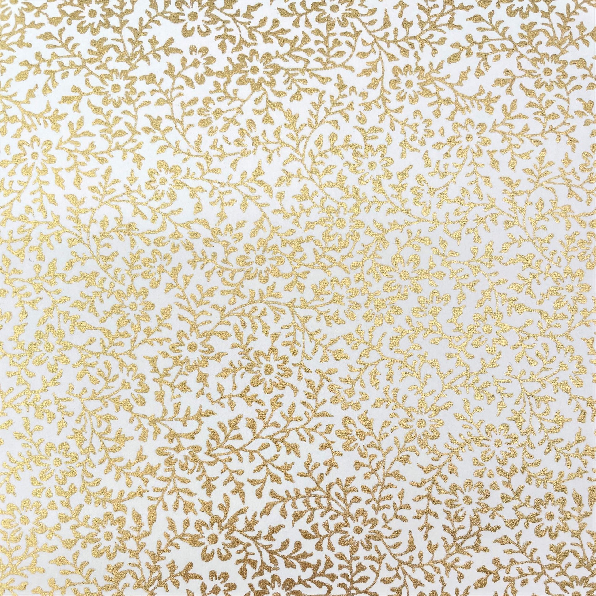 japanese silk-screen handmade paper showing a dainty gold botanical repeat design on ivory backdrop
