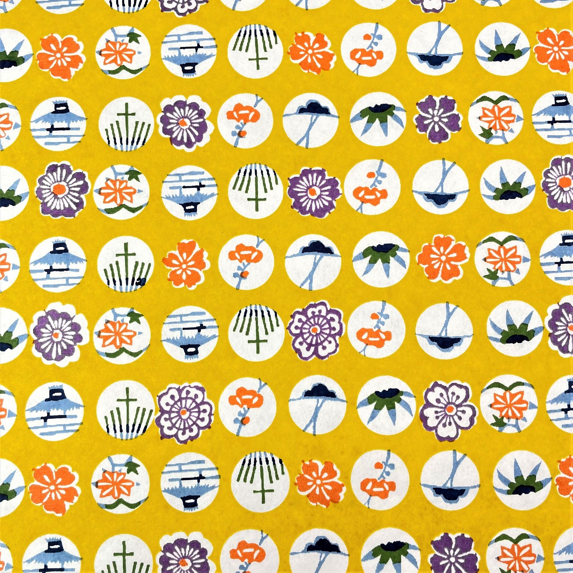 japanese silk-screen handmade paper showing circles of traditional motifs on yellow backdrop