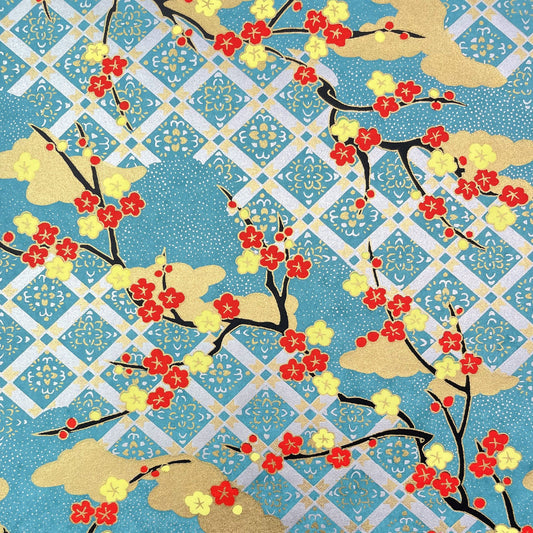 japanese silk-screen handmade paper showing branches of red blossom, gold clouds on a teal, gold and silver geometric backdrop.